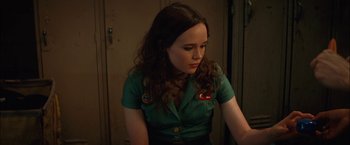 Movie still from “Whip It” (2009), directed by Drew Barrymore – A woman in a green shirt is looking down; Close Up shot, Over the shoulder angle