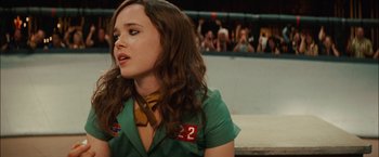 Movie still from “Whip It” (2009), directed by Drew Barrymore – A woman in a green shirt and a yellow tie; Close Up shot, Over the shoulder angle