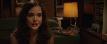 Movie still from “Whip It” (2009), directed by Drew Barrymore – A beautiful young lady sitting in a living room; Close Up shot, Over the shoulder angle