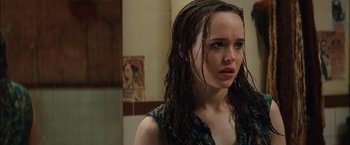 Movie still from “Whip It” (2009), directed by Drew Barrymore – A young woman with wet hair stares into the camera; Close Up shot, Over the shoulder angle