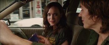 Movie still from “Whip It” (2009), directed by Drew Barrymore – A woman sitting in the back seat of a car; Close Up shot, Over the shoulder angle