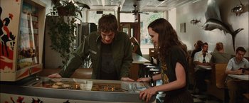 Movie still from “Whip It” (2009), directed by Drew Barrymore – A man and a woman looking at a pinball machine; Medium shot, Over the shoulder angle