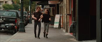 Movie still from “Whip It” (2009), directed by Drew Barrymore – A man and a woman walking down a street; Wide shot, Over the shoulder angle