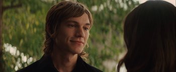 Movie still from “Whip It” (2009), directed by Drew Barrymore – A man with long hair and a black shirt; Close Up shot, Over the shoulder angle