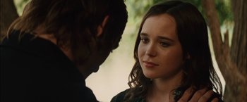 Movie still from “Whip It” (2009), directed by Drew Barrymore – A young woman looking at a young man in front of a tree; Close Up shot, Over the shoulder angle