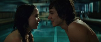 Movie still from “Whip It” (2009), directed by Drew Barrymore – A man and a woman face to face near a swimming pool; Close Up shot, Over the shoulder angle