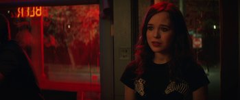 Movie still from “Whip It” (2009), directed by Drew Barrymore – A woman with pink hair standing in a room; Close Up shot, Over the shoulder angle