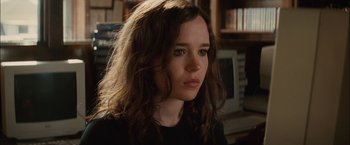 Movie still from “Whip It” (2009), directed by Drew Barrymore – A woman with long hair is looking to her left; Close Up shot, Over the shoulder angle