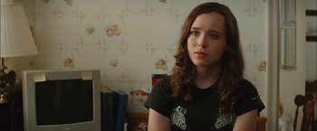 Movie still from “Whip It” (2009), directed by Drew Barrymore – A woman in a black shirt sitting in front of a computer; Close Up shot, Over the shoulder angle