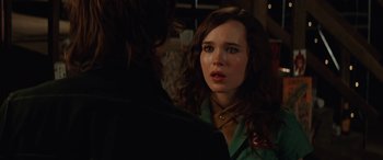 Movie still from “Whip It” (2009), directed by Drew Barrymore – A young woman looking at the camera while talking to a man; Close Up shot, Over the shoulder angle