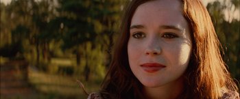 Movie still from “Whip It” (2009), directed by Drew Barrymore – A young woman's face in a wooded area; Close Up shot, Over the shoulder angle