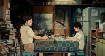 Movie still from “Whisper of the Heart” (1995), directed by Yoshifumi Kondô – A couple of people sitting at a dinner table together; Wide shot, Low angle