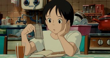 Movie still from “Whisper of the Heart” (1995), directed by Yoshifumi Kondô – A boy sitting at a table holding a book; Close Up shot, High angle
