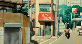Movie still from “Whisper of the Heart” (1995), directed by Yoshifumi Kondô – An asian building with a fire hydrant on the side of the street; Extreme Wide shot, Low angle