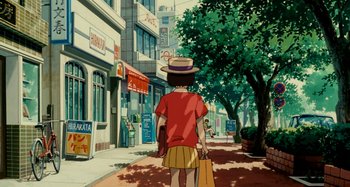 Movie still from “Whisper of the Heart” (1995), directed by Yoshifumi Kondô – A person walking down a street holding a shopping bag; Wide shot, High angle