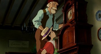 Movie still from “Whisper of the Heart” (1995), directed by Yoshifumi Kondô – An old man standing next to a young boy; Medium shot, Low angle