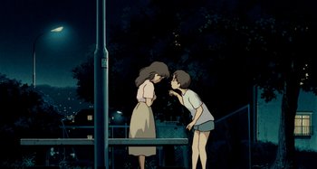 Movie still from “Whisper of the Heart” (1995), directed by Yoshifumi Kondô – Two people standing next to each other near a railing at night; Wide shot, Low angle