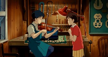 Movie still from “Whisper of the Heart” (1995), directed by Yoshifumi Kondô – A man and a boy playing a violin in a workshop; Medium shot, Low angle