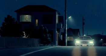 Movie still from “Whisper of the Heart” (1995), directed by Yoshifumi Kondô – A car driving down a street at night; Extreme Wide shot, Low angle