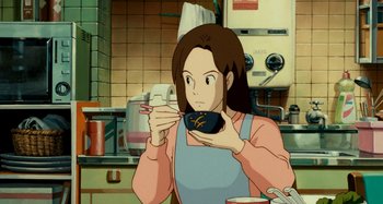 Movie still from “Whisper of the Heart” (1995), directed by Yoshifumi Kondô – A woman in an apron is holding a bowl in a kitchen; Medium shot, High angle