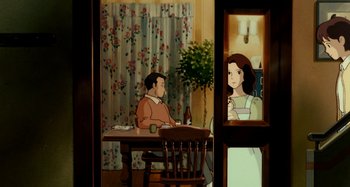 Movie still from “Whisper of the Heart” (1995), directed by Yoshifumi Kondô – A man and a woman sitting at a dinner table in front of a window; Medium shot, Over the shoulder angle