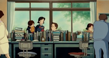 Movie still from “Whisper of the Heart” (1995), directed by Yoshifumi Kondô – A group of people sitting at a table with a lot of books; Wide shot, High angle