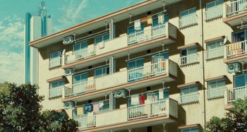 Movie still from “Whisper of the Heart” (1995), directed by Yoshifumi Kondô – A building that has many balconies on it; Extreme Wide shot, Low angle