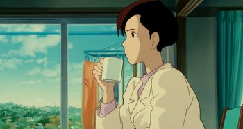 Movie still from “Whisper of the Heart” (1995), directed by Yoshifumi Kondô – A woman drinking a glass of milk in front of a window; Medium shot, Over the shoulder angle