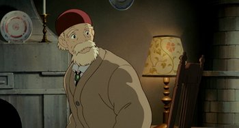 Movie still from “Whisper of the Heart” (1995), directed by Yoshifumi Kondô – An old man standing next to a lamp in a room; Medium shot, High angle