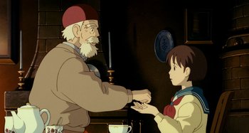 Movie still from “Whisper of the Heart” (1995), directed by Yoshifumi Kondô – An old man and a young boy are shaking hands; Medium shot, Over the shoulder angle