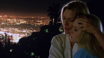 Movie still from “White Oleander” (2002), directed by Peter Kosminsky – A woman and a child looking at a city at night; Close Up shot, Low angle