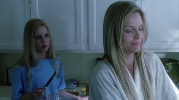 Movie still from “White Oleander” (2002), directed by Peter Kosminsky – Two women in a kitchen one is holding a knife and the other is holding a knife; Close Up shot, Over the shoulder angle