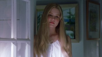 Movie still from “White Oleander” (2002), directed by Peter Kosminsky – A young girl with long blonde hair standing by a window; Close Up shot, Low angle