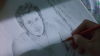 Movie still from “White Oleander” (2002), directed by Peter Kosminsky – A person is drawing a picture of a man; Extreme Close Up shot, High angle