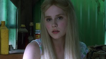 Movie still from “White Oleander” (2002), directed by Peter Kosminsky – A woman with long blonde hair sitting in a room; Close Up shot, Low angle