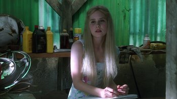 Movie still from “White Oleander” (2002), directed by Peter Kosminsky – A woman with long blonde hair sitting on a chair; Close Up shot, Over the shoulder angle