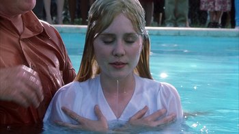 Movie still from “White Oleander” (2002), directed by Peter Kosminsky – A woman in a white shirt is in the water; Close Up shot, High angle