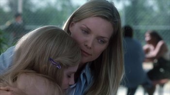 Movie still from “White Oleander” (2002), directed by Peter Kosminsky – A woman and a child are hugging each other; Close Up shot, Over the shoulder angle