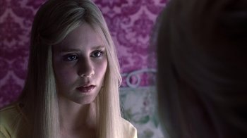 Movie still from “White Oleander” (2002), directed by Peter Kosminsky – A young woman looking into a mirror in front of a mirror; Close Up shot, Over the shoulder angle