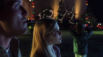 Movie still from “White Oleander” (2002), directed by Peter Kosminsky – A young girl is looking up at a christmas tree; Close Up shot, Low angle