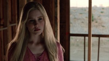Movie still from “White Oleander” (2002), directed by Peter Kosminsky – A young blonde woman in a pink dress looking at the camera; Close Up shot, Over the shoulder angle