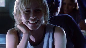 Movie still from “White Oleander” (2002), directed by Peter Kosminsky – A woman smiling with her hand on her chin; Close Up shot, Over the shoulder angle