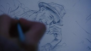 Movie still from “White Oleander” (2002), directed by Peter Kosminsky – A person drawing a picture of a man wearing a hat; Extreme Close Up shot, Low angle