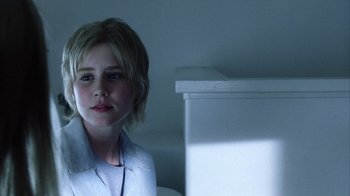 Movie still from “White Oleander” (2002), directed by Peter Kosminsky – A young girl sitting in front of a white box; Close Up shot, Over the shoulder angle