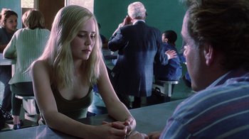Movie still from “White Oleander” (2002), directed by Peter Kosminsky – A woman sitting at a table with a man in a suit; Close Up shot, Over the shoulder angle