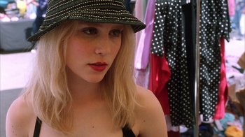 Movie still from “White Oleander” (2002), directed by Peter Kosminsky – A woman wearing a black hat and a black top; Close Up shot, High angle