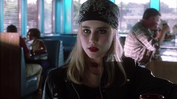 Movie still from “White Oleander” (2002), directed by Peter Kosminsky – A woman in a black leather jacket and a black hat; Close Up shot, Over the shoulder angle