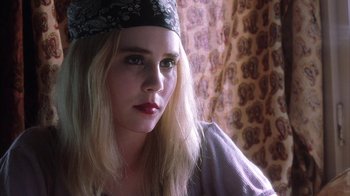 Movie still from “White Oleander” (2002), directed by Peter Kosminsky – A beautiful young lady with long blonde hair wearing a hat; Close Up shot, High angle