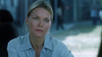Movie still from “White Oleander” (2002), directed by Peter Kosminsky – A woman in a white shirt is looking at the camera; Close Up shot, Over the shoulder angle
