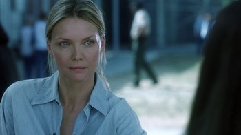 Movie still from “White Oleander” (2002), directed by Peter Kosminsky – A beautiful woman with blue eyes looking at the camera; Close Up shot, Over the shoulder angle